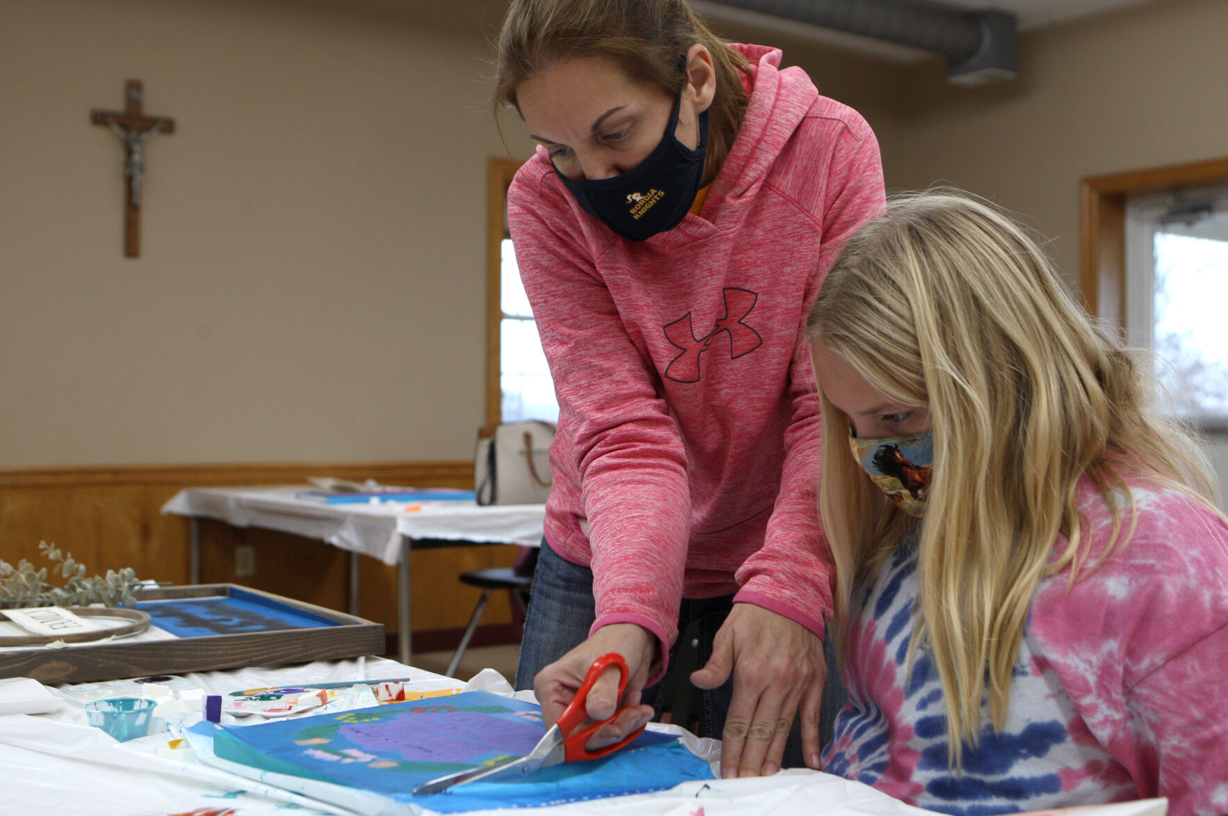 Amie Kohlbusch helps Lilly Raaf